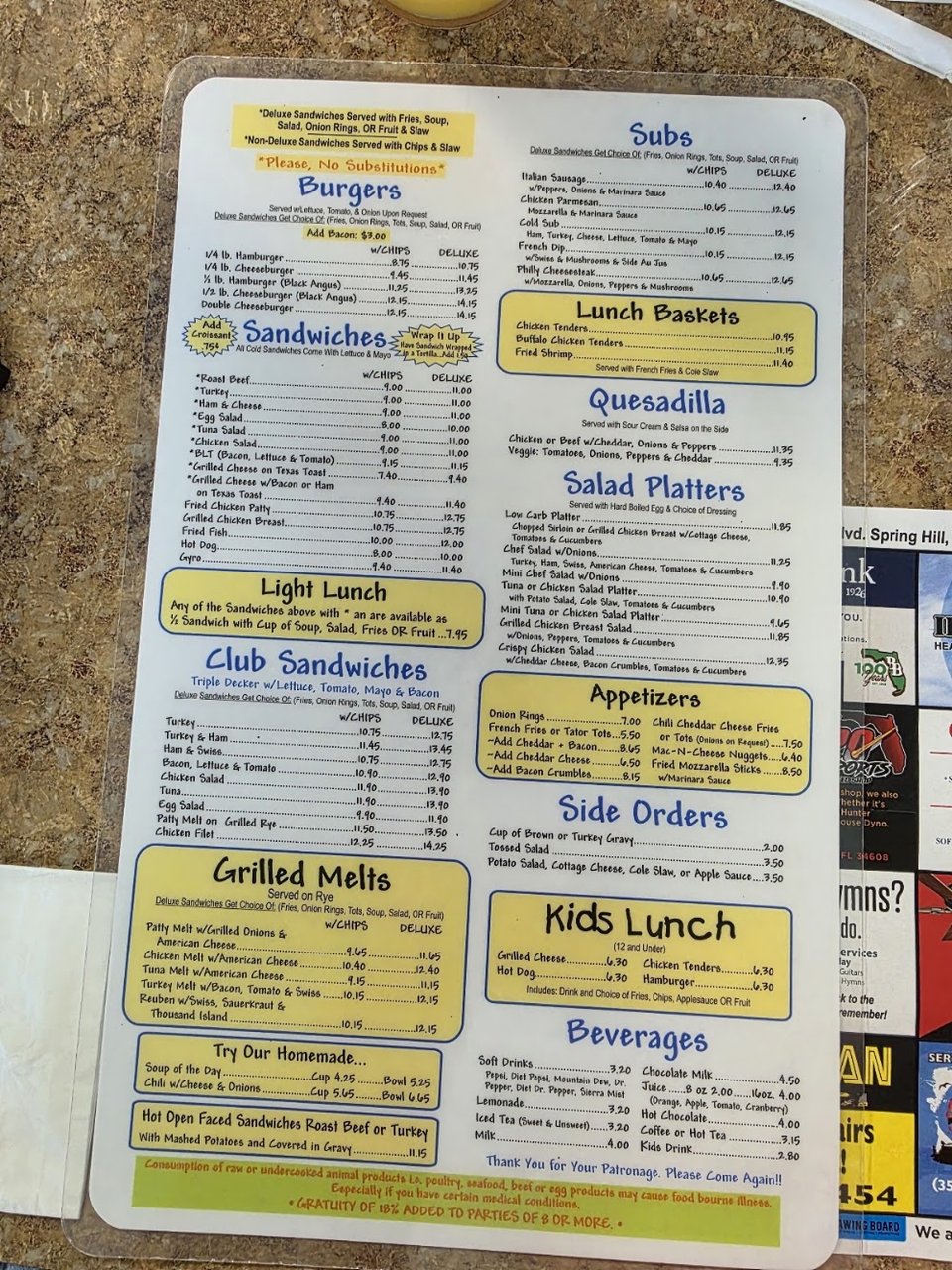 Printed breakfast menu beside a coffee cup.